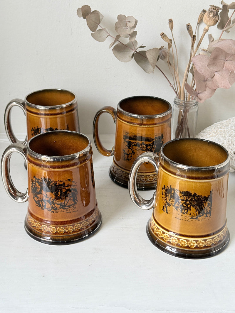 Set of 4 large Ridgways stoneware beer tankards photographed on a white surface in amber treacle glaze with black Coaching Days and Coaching Ways transfer scenes