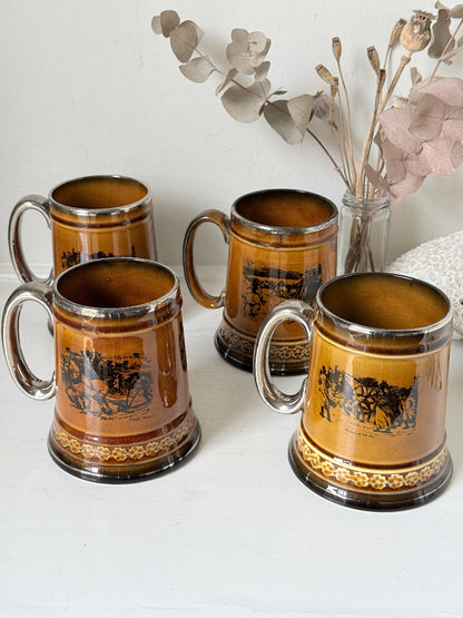 Set of 4 large Ridgways stoneware beer tankards photographed on a white surface in amber treacle glaze with black Coaching Days and Coaching Ways transfer scenes