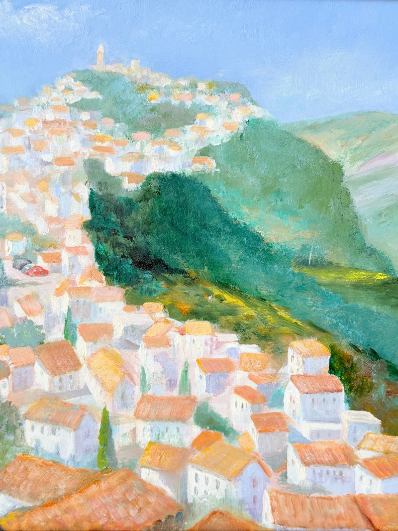 Framed oil painting of Costa del Sol with whitewashed hillside towns, photographed on a white surface