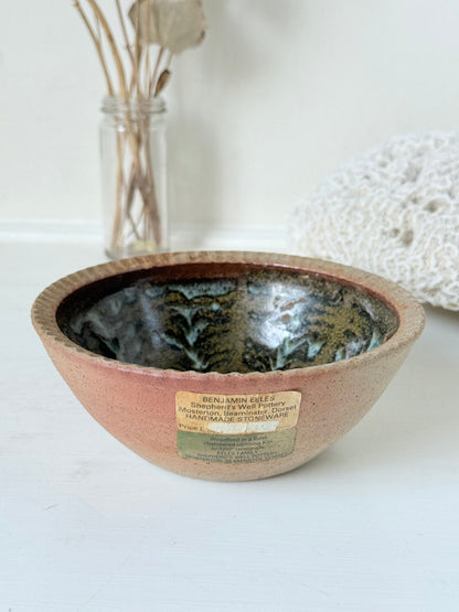 Benjamin Eeles studio pottery stoneware bowl with green and blue glazed interior on a white surface.