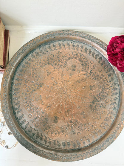 Vintage hand engraved copper tray with sunburst centre, decorative border and aged verdigris patina for wall or tabletop styling