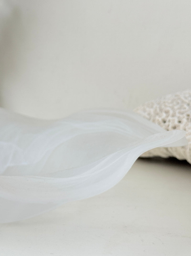 Large vintage white matt glass swirl ruffle bowl photographed on a white surface