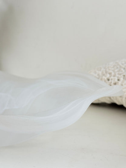 Large vintage white matt glass swirl ruffle bowl photographed on a white surface