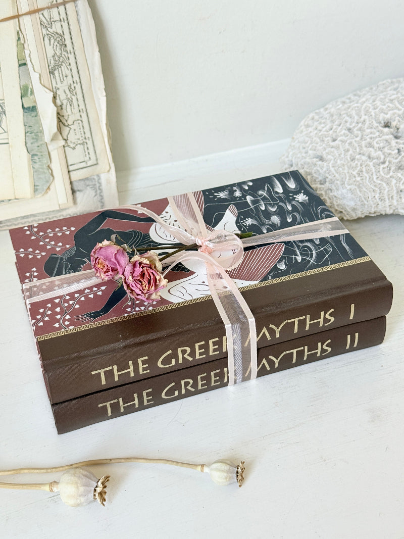 Pair of vintage Greek myths books with brown illustrated covers, pale pink ribbon and dried flower detail for shelf styling