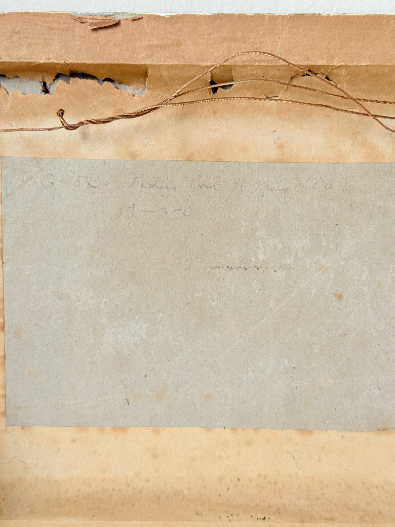 Close-up of the back of a vintage paper card or document, showing a beige central sheet with faint handwritten text, bordered by aged tan paper and a torn brown cardboard edge with loose string.