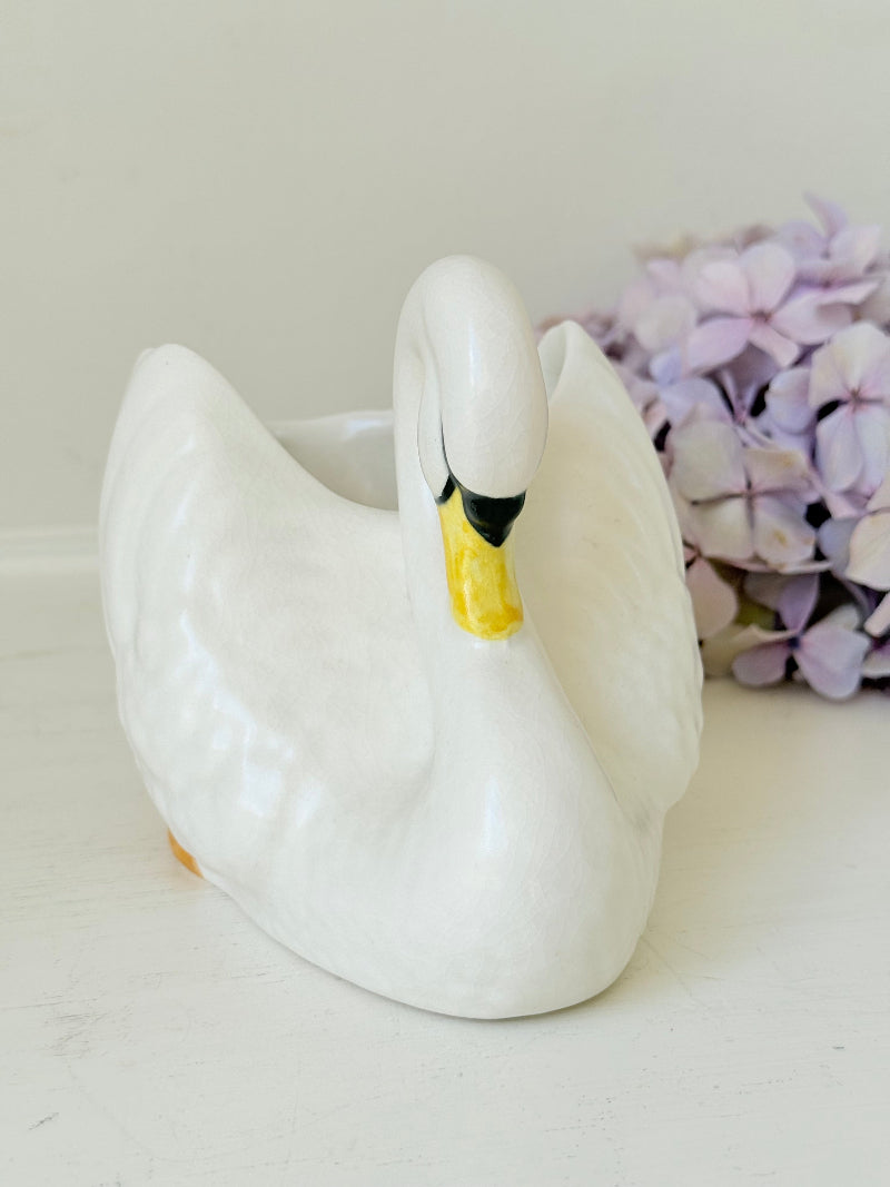 Vintage Sylvac swan planter in white ceramic with yellow beak and feet, styled on a white surface