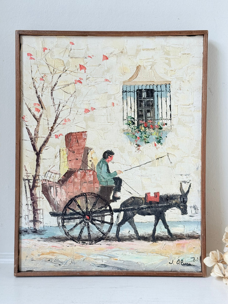 Vintage framed oil painting of horse and cart scene signed L. Cabanes photographed on a white surface