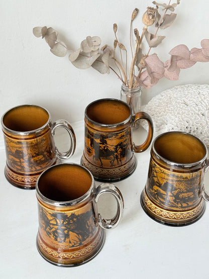 Set of 4 large Ridgways stoneware beer tankards photographed on a white surface in amber treacle glaze with black Coaching Days and Coaching Ways transfer scenes