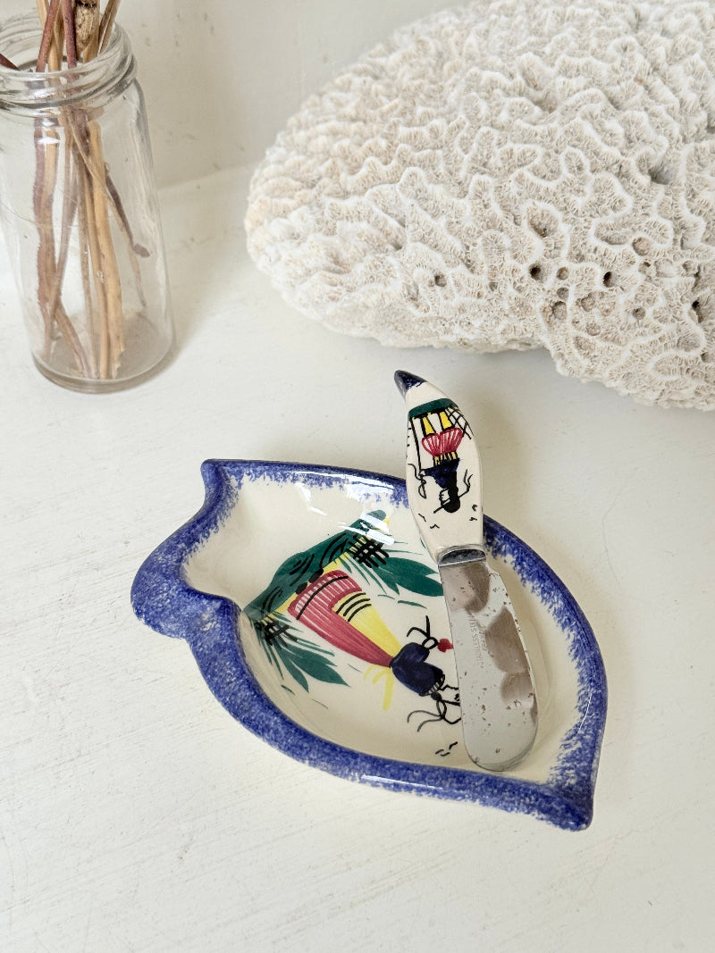 Vintage Quimper butter dish with ceramic knife, hand painted Breton figure, photographed on a white surface