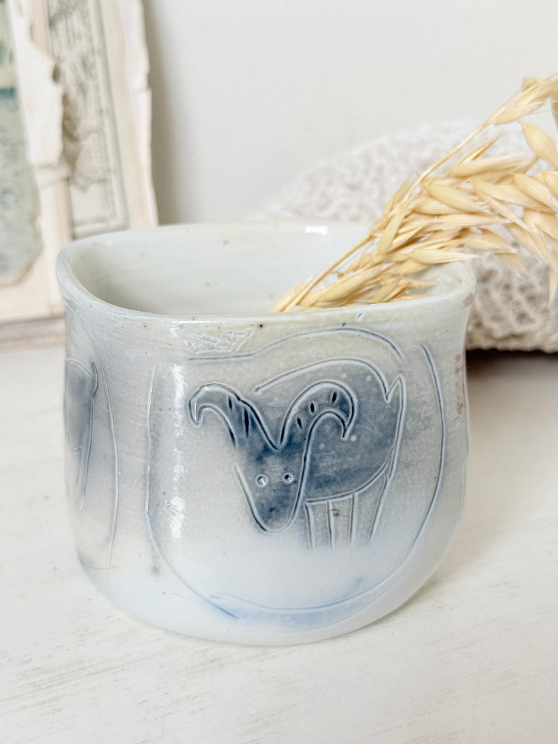 Hand painted ceramic pot with blue ram motif, pale grey off white glaze and handmade decorative form