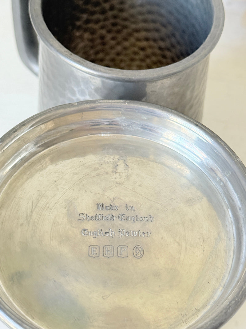 Pair of hammered English pewter tankards by E H Parkin of Sheffield, photographed on a white surface
