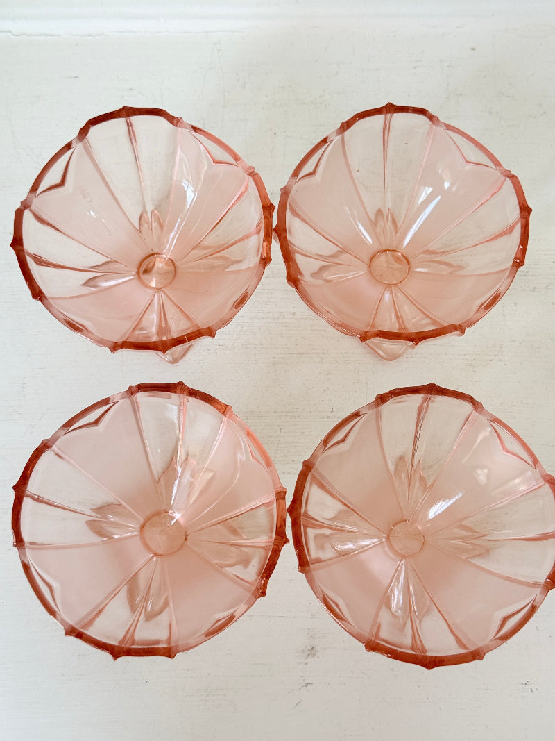 Art Deco pink pressed glass dessert service with scalloped serving bowl and four footed sundae dishes