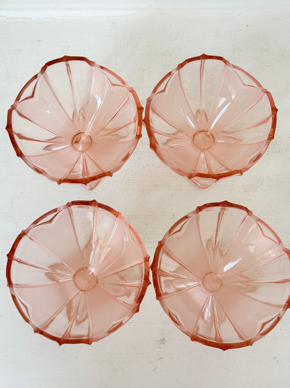Art Deco pink pressed glass dessert service with scalloped serving bowl and four footed sundae dishes