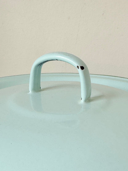 Vintage pale blue enamel bread bin with lid and handles, photographed on a white surface