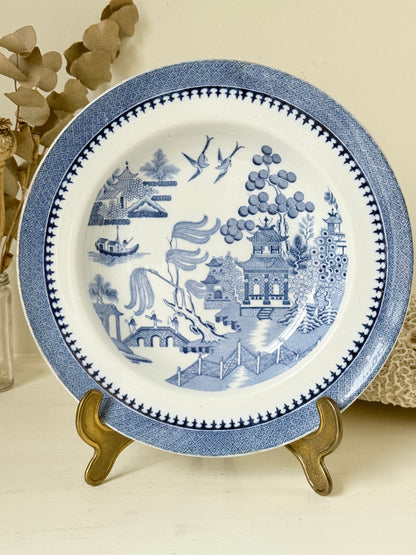 Minton Blue Willow serving dish dated 1928 with blue transfer pattern shown on a white surface.