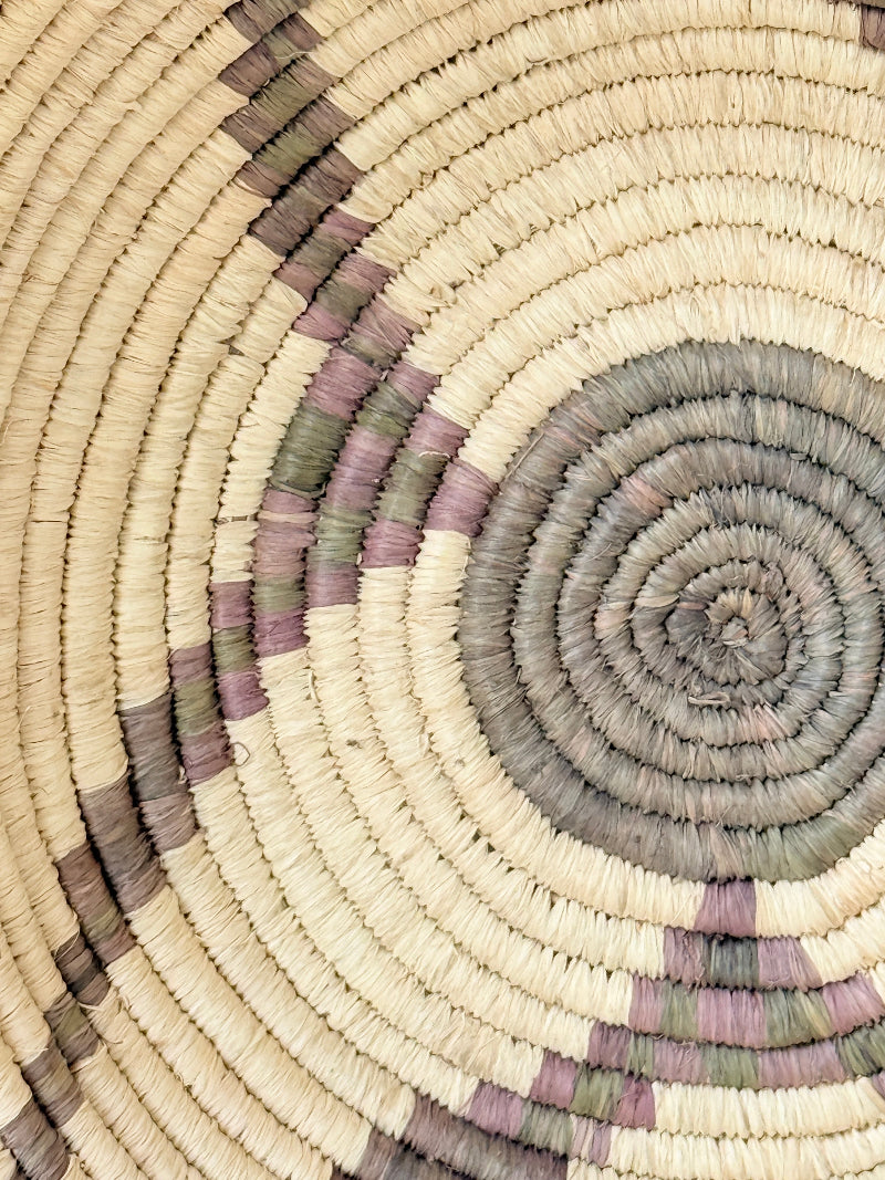 Large hand woven coiled basket with three point star pattern, natural fibre and dark geometric detail for wall or table styling