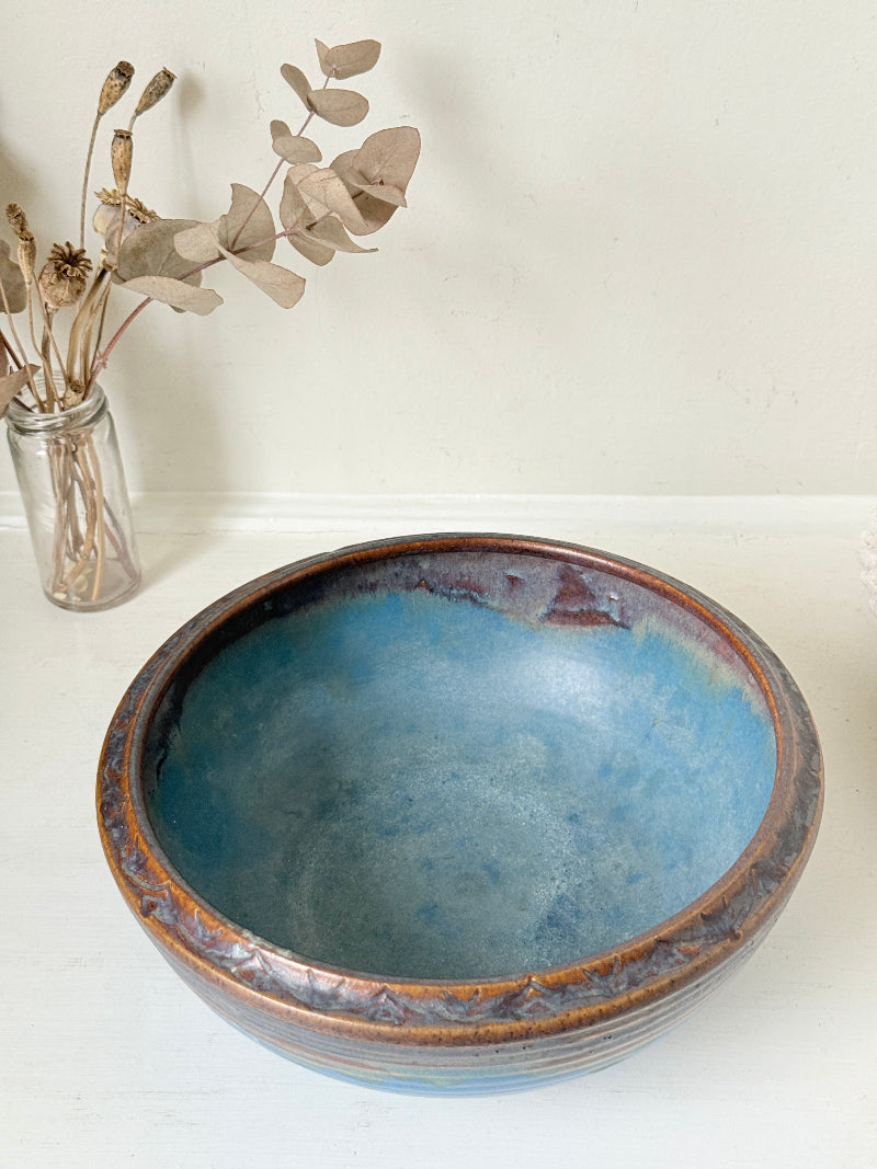 Vintage Bourne Denby stoneware fruit bowl in blue and brown glaze, photographed on a white surface