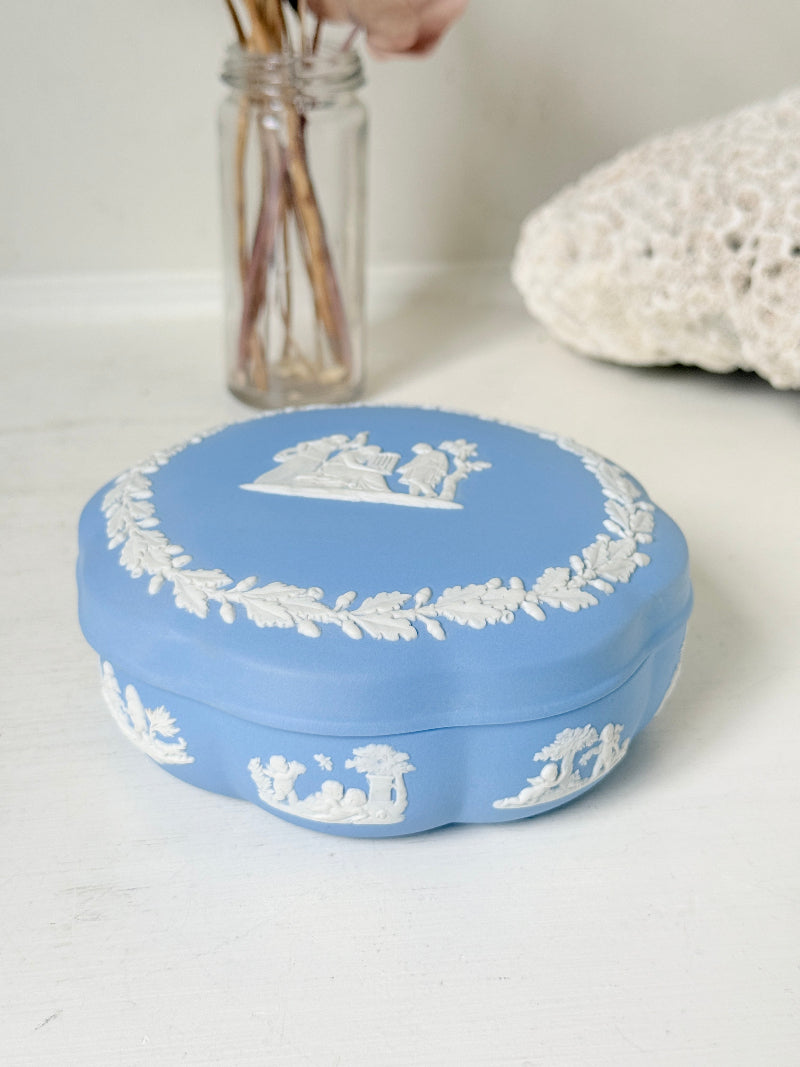 Vintage Wedgwood pale blue Jasperware lidded trinket box with a scalloped base, decorated with a white neoclassical cameo and laurel wreath border.