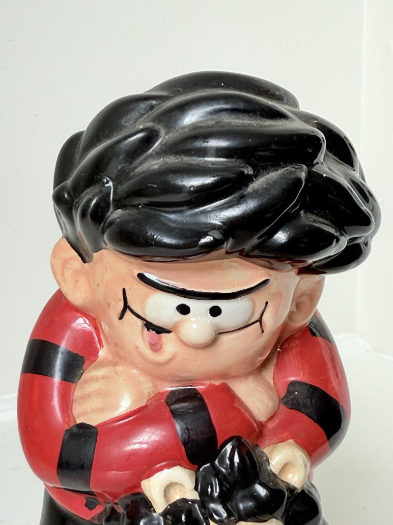 Dennis the Menace and Gnasher ceramic moneybox in red and black comic-style outfits, with vintage hand-painted detail.