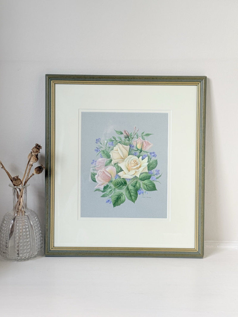 Framed pencil drawing of pale yellow and blush roses with green leaves and purple flowers on a soft grey background, signed by artist Pam Ford.