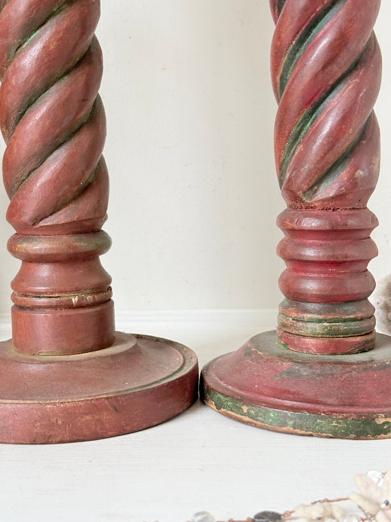 Vintage wooden barley twist candlesticks, a pair with painted finish, photographed on a white surface