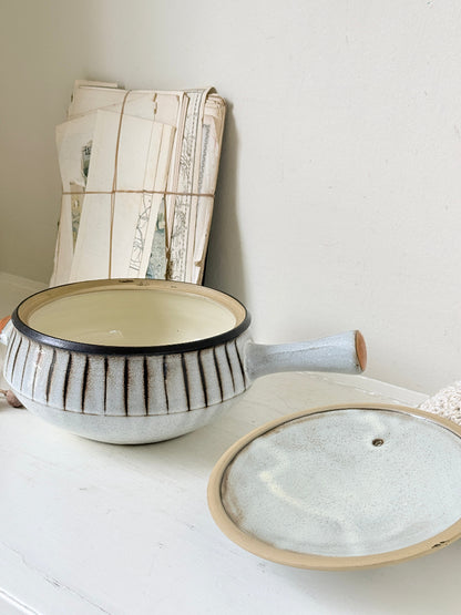 Denby Studio large two handled lidded casserole in grey and rust photographed on a white surface