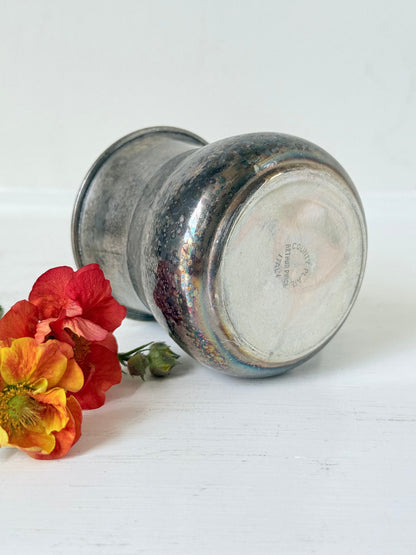 vintage silver plate beaker by arthur price with ornate handle and patina, photographed with red flowers on a white surface