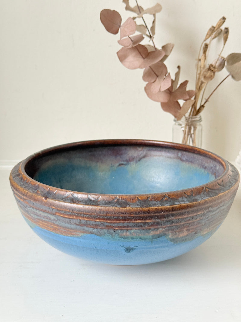 Vintage Bourne Denby stoneware fruit bowl in blue and brown glaze, photographed on a white surface