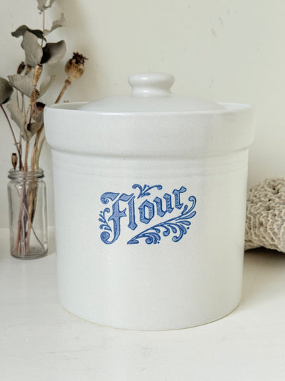 Pfaltzgraff Yorktowne stoneware flour pot with blue floral motif and lid, photographed on a white surface