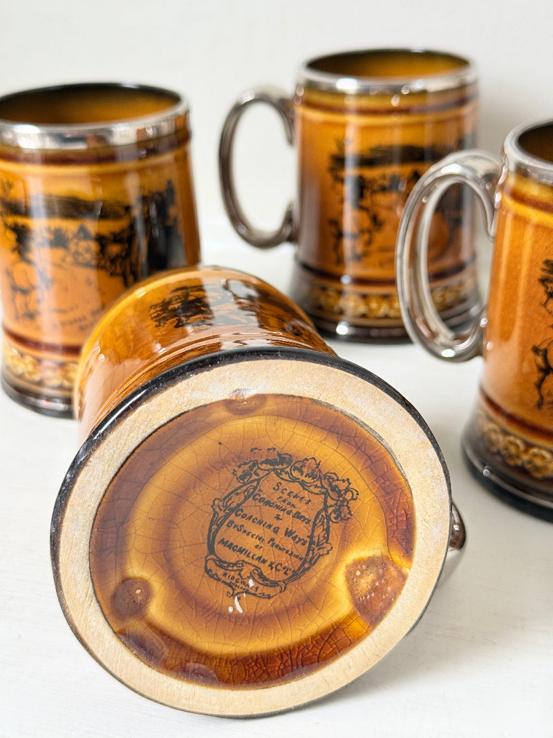 Set of 4 Ridgways stoneware tankard mugs photographed on a white surface in amber brown treacle glaze with black Coaching Days and Coaching Ways transfer scenes