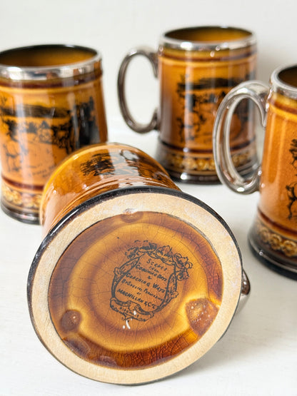 Set of 4 Ridgways stoneware tankard mugs photographed on a white surface in amber brown treacle glaze with black Coaching Days and Coaching Ways transfer scenes