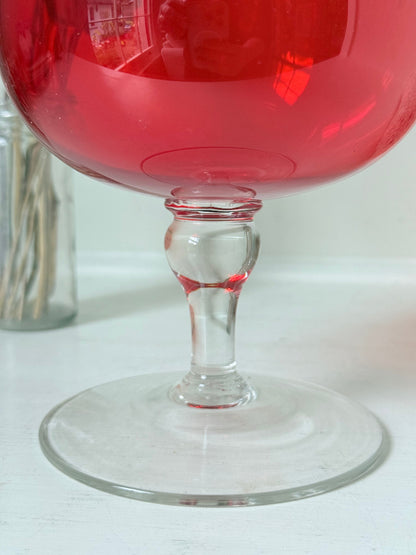 Large retro red glass brandy glass displayed on a white background.