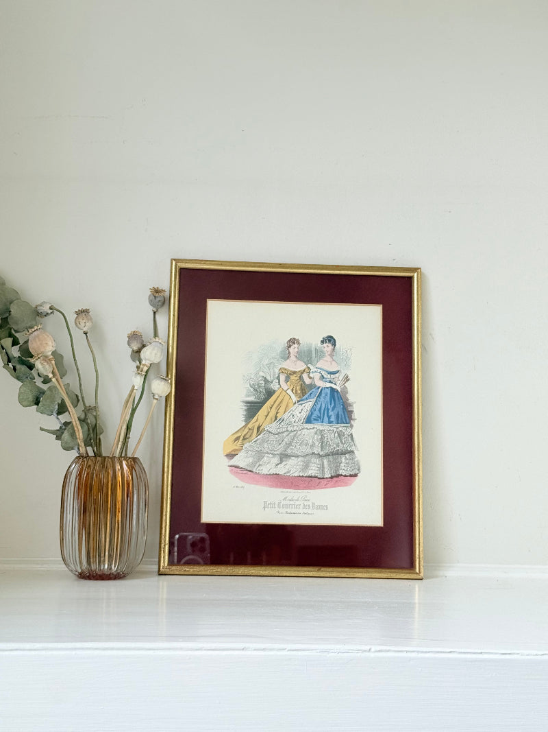 Vintage Modes de Paris fashion plate with gilt frame and burgundy mount, photographed on white surface