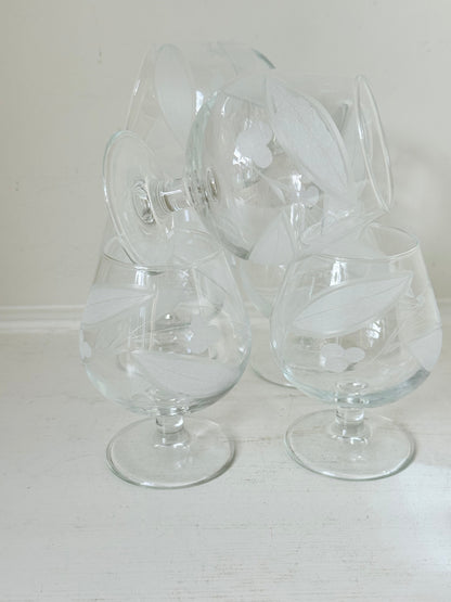 Set of six vintage etched Bailey’s glasses with rounded bowls and short stems, photographed on white surface.
