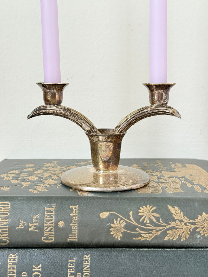 Vintage miniature silver plate candlestick with twin holders, photographed on white surface