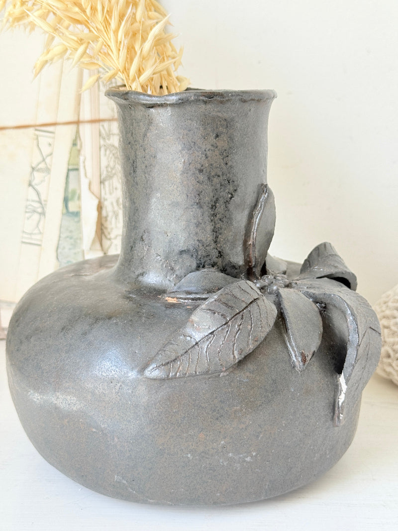 Studio pottery ceramic vase with liquorice grey glaze, applied floral and leaf detail and rounded handmade form