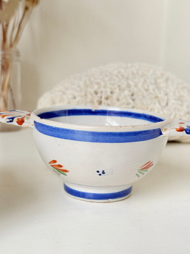 Pair of vintage French Quimper olive bowls with Breton figure and fan handles, photographed on a white surface