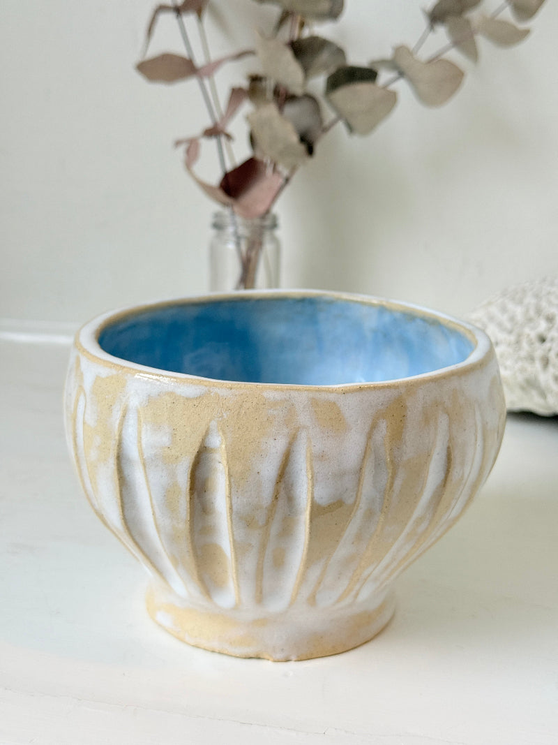 Vintage studio pottery bowl planter in cream and sky blue glaze photographed on a white surface