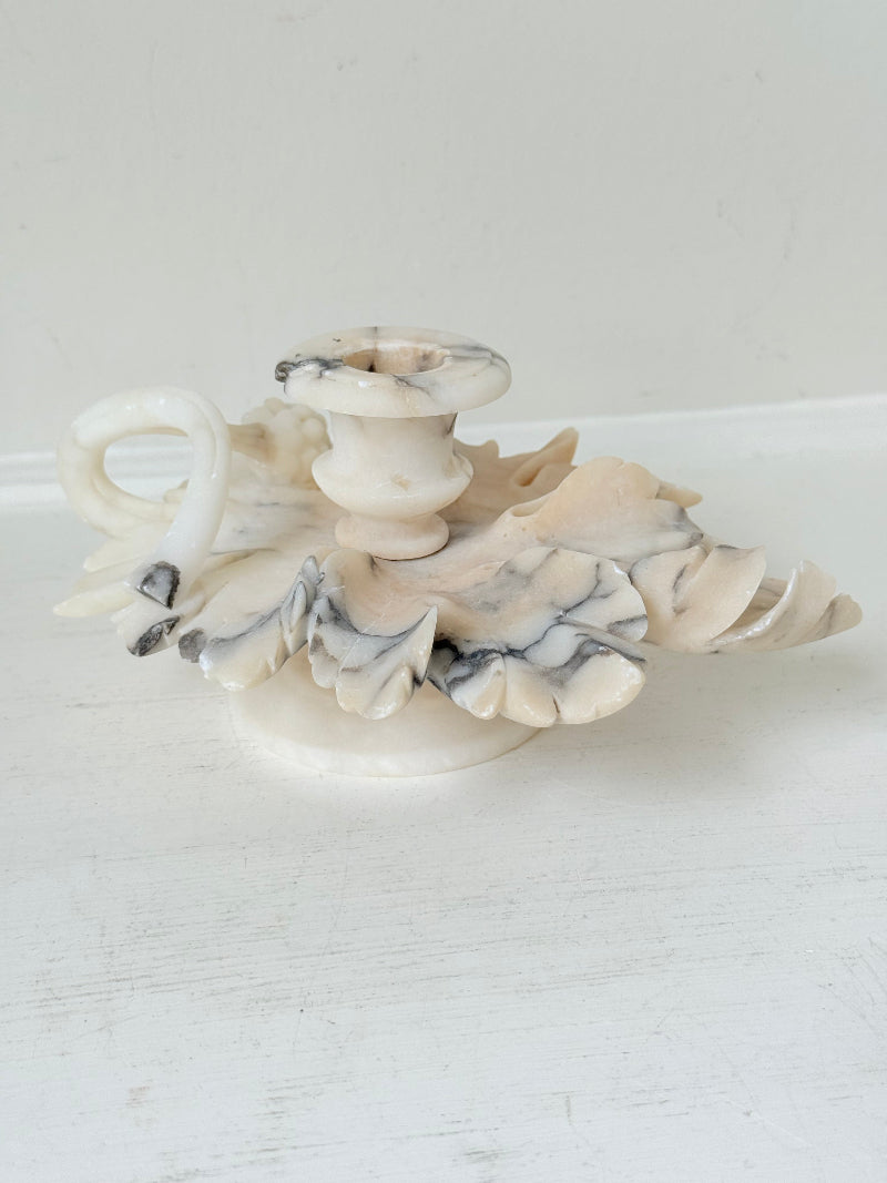 Antique alabaster marble floral candleholder with carved leaves and flowers, photographed on a white surface.