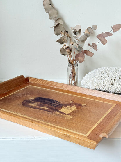 Vintage wooden tray with cat marquetry inlay, photographed on a white surface
