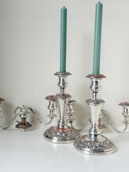 Pair of convertible silver plate on copper candelabra with repoussé detail, removable arms and green taper candles