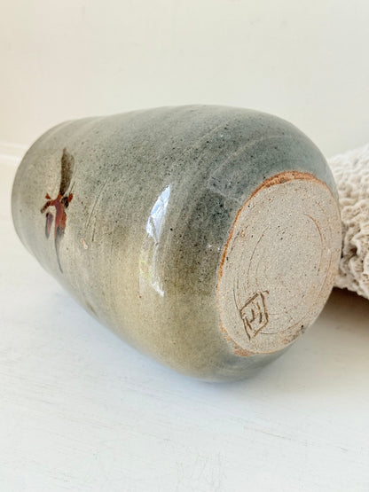 Hand thrown studio pottery vase with ash glaze and brushstroke motif, photographed on white surface