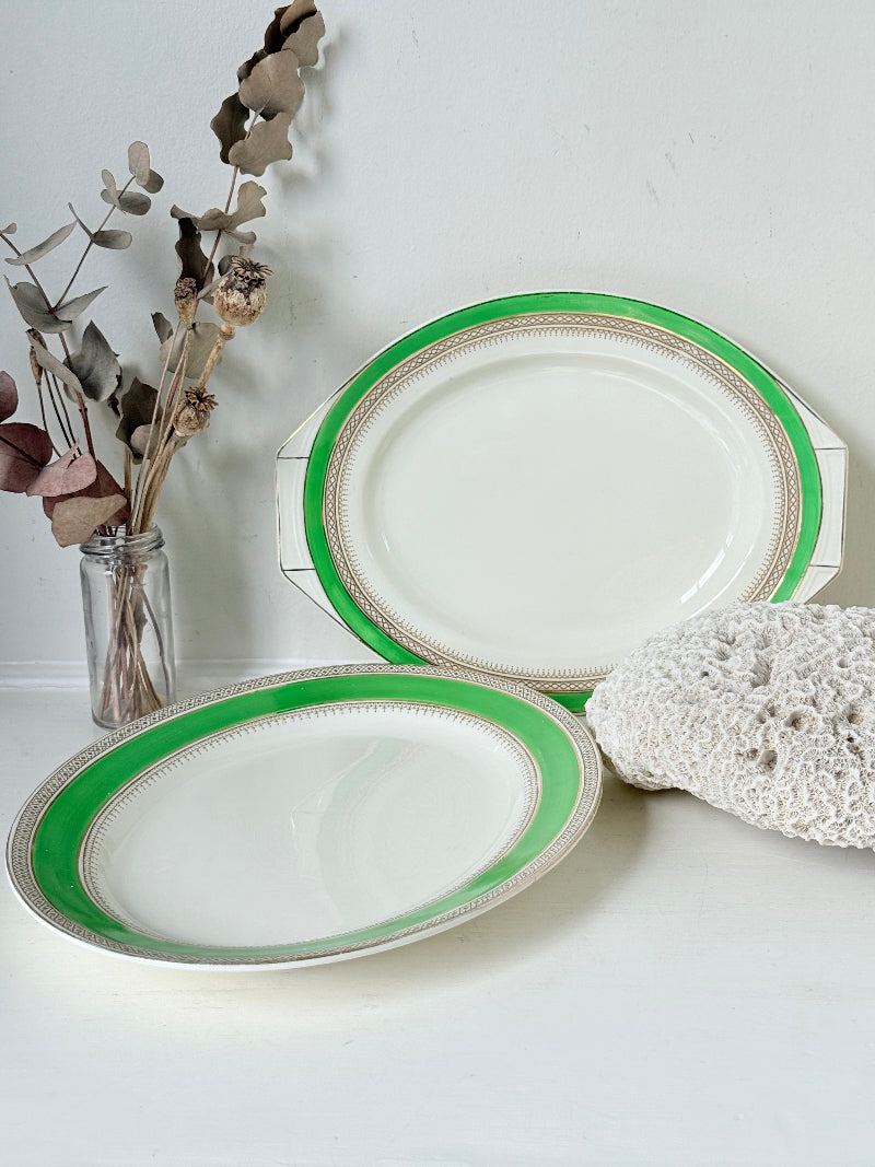 Pair of vintage oval serving platters with bright green Art Deco style border photographed on a white surface