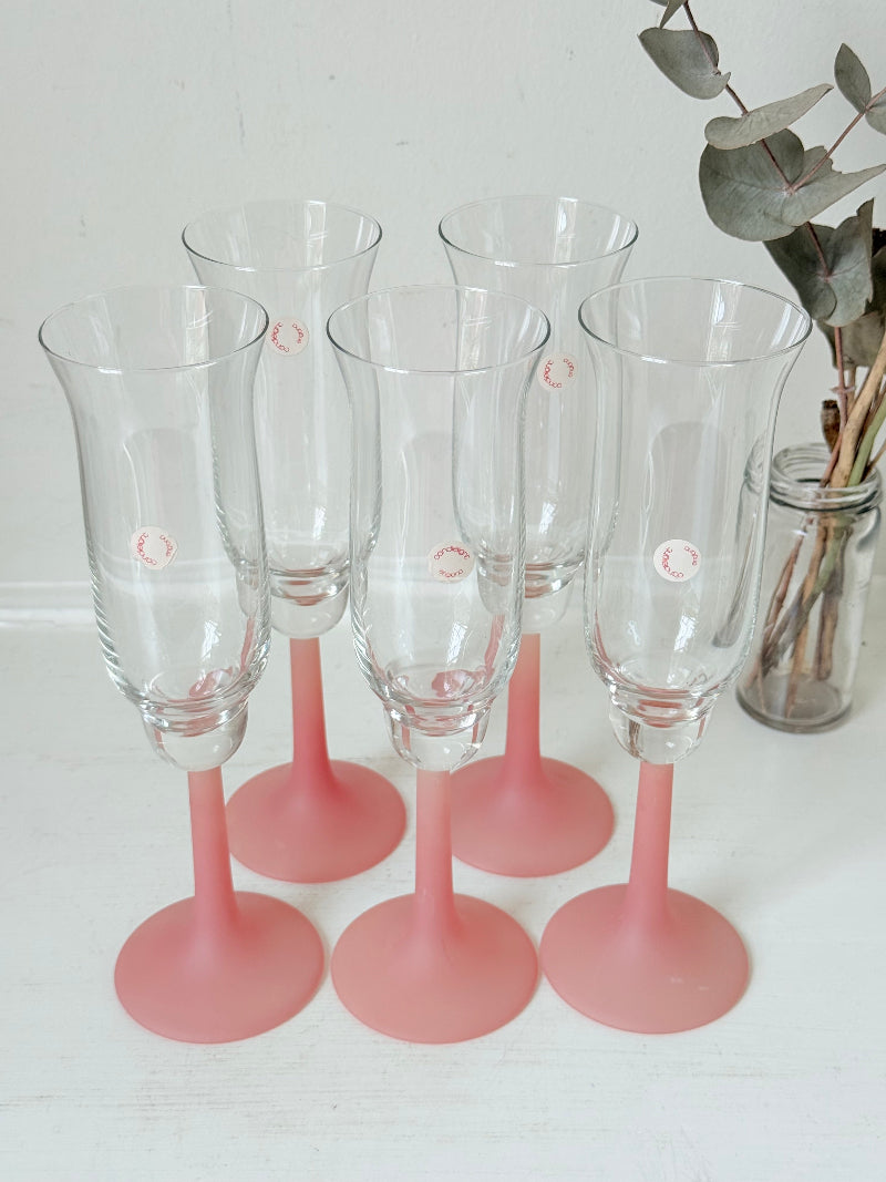 Set of five 1980s frosted pink tulip champagne flutes from the Candlelight range, photographed on a white surface