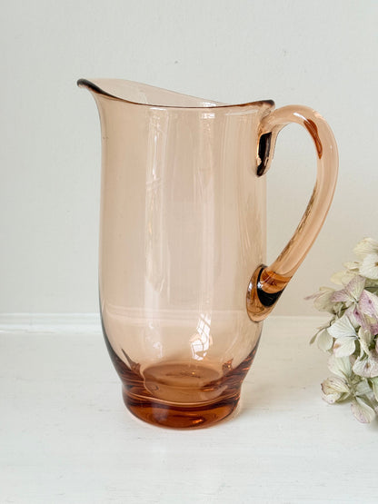 retro apricot glass serving jug with curved handle and flared spout, photographed on white surface