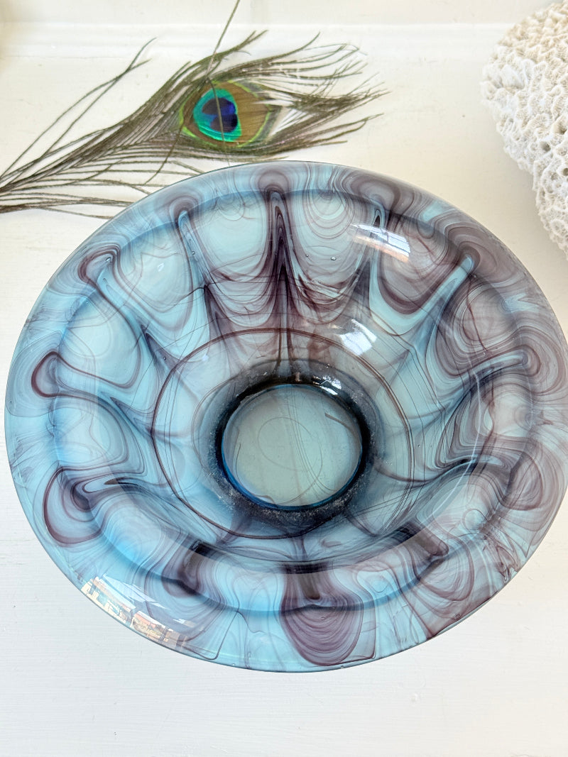 George Davidson blue cloud glass bowl with purple marbled swirls, photographed on a white surface
