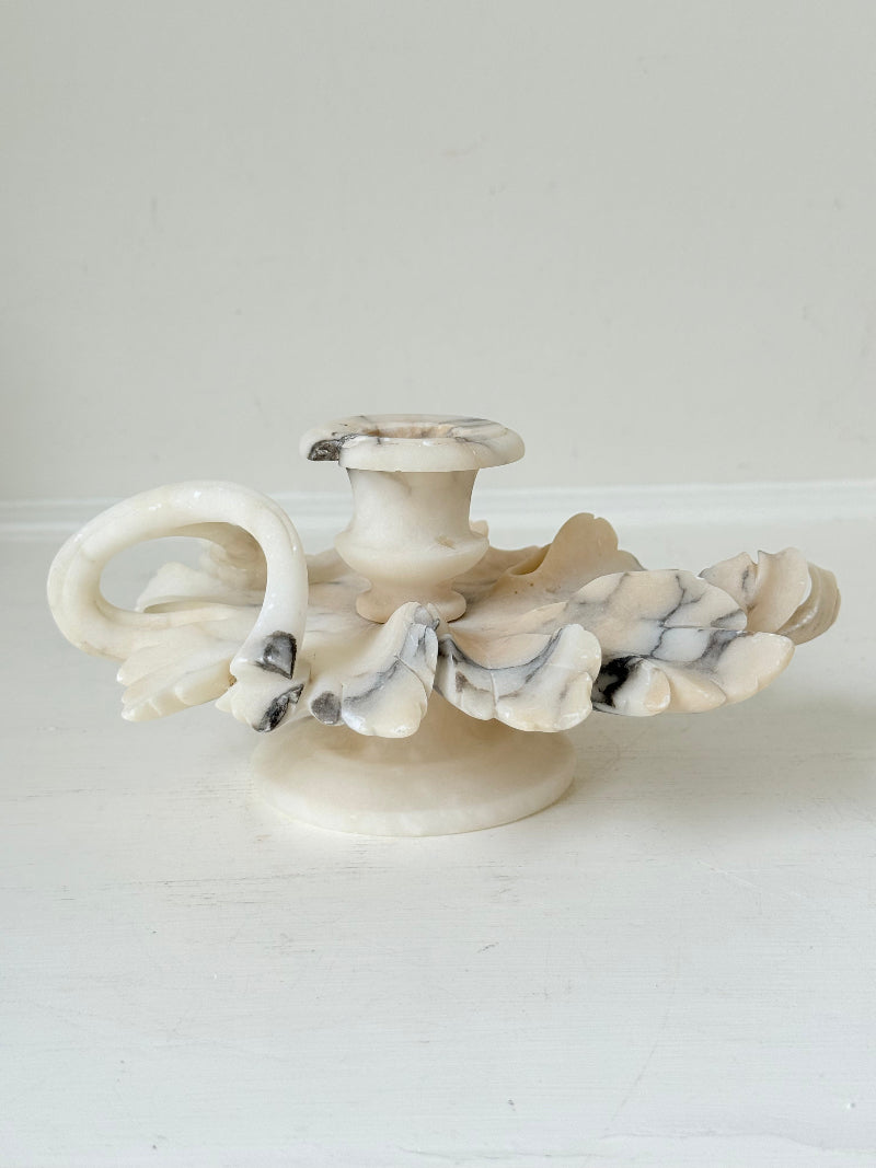 Antique alabaster marble floral candleholder with carved leaves and flowers, photographed on a white surface.