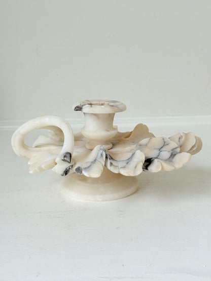 Antique alabaster marble floral candleholder with carved leaves and flowers, photographed on a white surface.