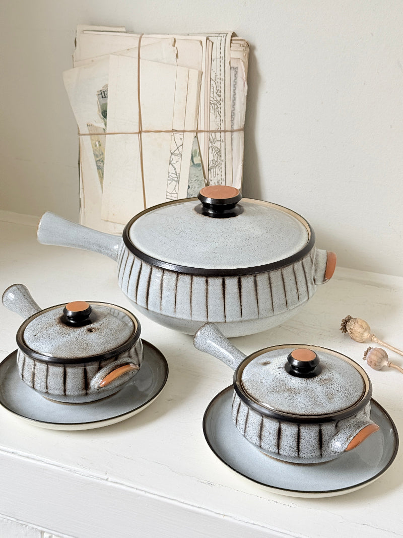 Denby Studio stoneware casserole and soup bowl set in grey and rust photographed on a white surface