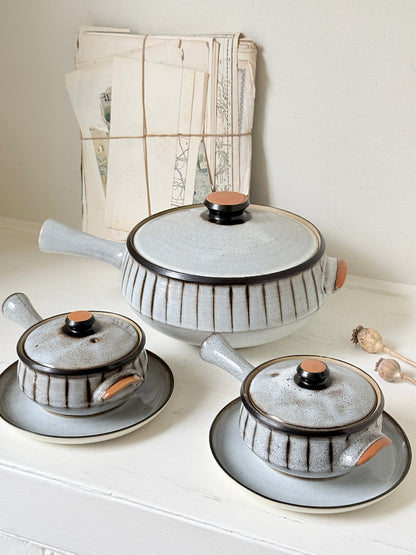 Denby Studio stoneware casserole and soup bowl set in grey and rust photographed on a white surface